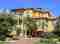 Exterior of yellow home with curved staircase painted by Pelican Painting Company in Sarasota